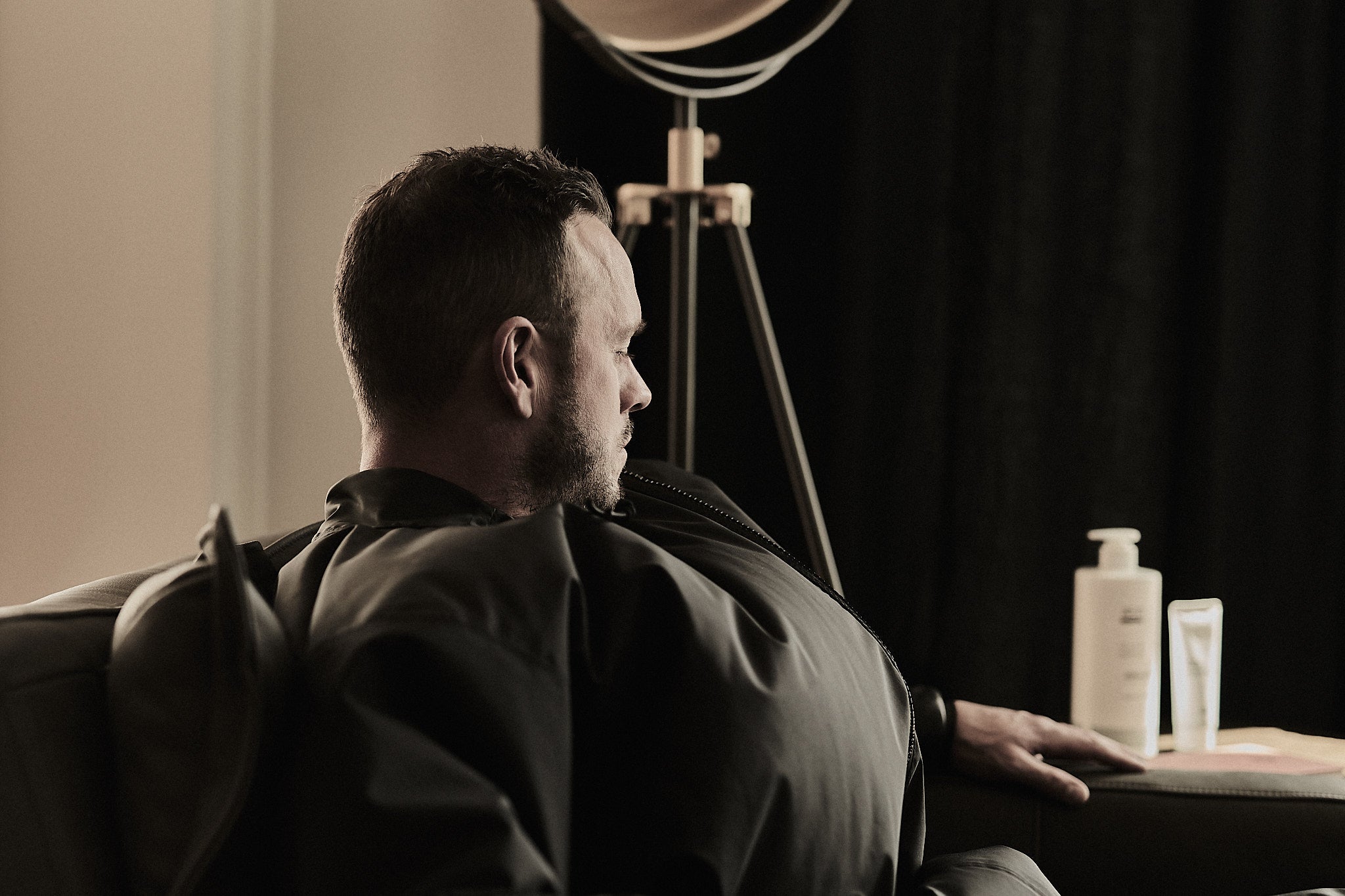 Person seated at home in an AEIR CO2 Flex Suit, calm and relaxed. Recovery that fits into real life.